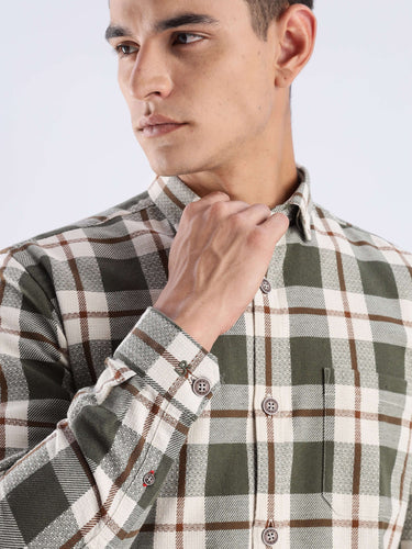 Stylish man wearing Meteor Green recycled cotton checked shirt, showcasing its sustainable fabric and durable design.
