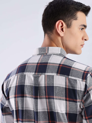 Back view of a man wearing the Turms recycled cotton checked shirt, showcasing its stylish and sustainable design.