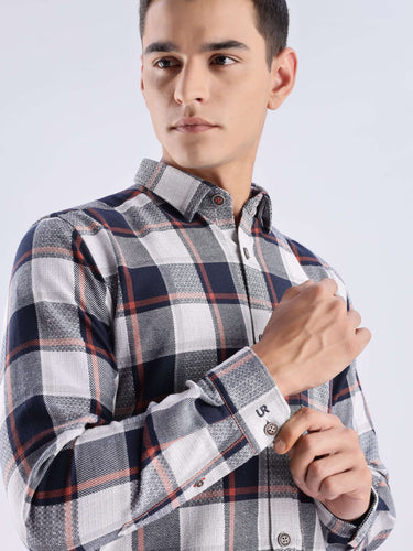 Man in a stylish blue matrix checked shirt made from recycled cotton, showcasing durability and modern design.