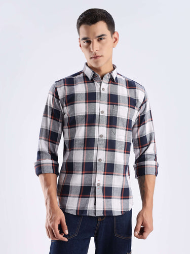 Stylish man wearing a blue and white checked recycled cotton shirt, showcasing sustainable fashion and cool tech features.