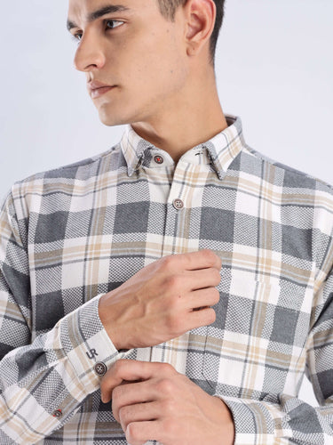 Man wearing the Urban Ochre Turms recycled cotton checked shirt, showcasing stylish and sustainable fashion.