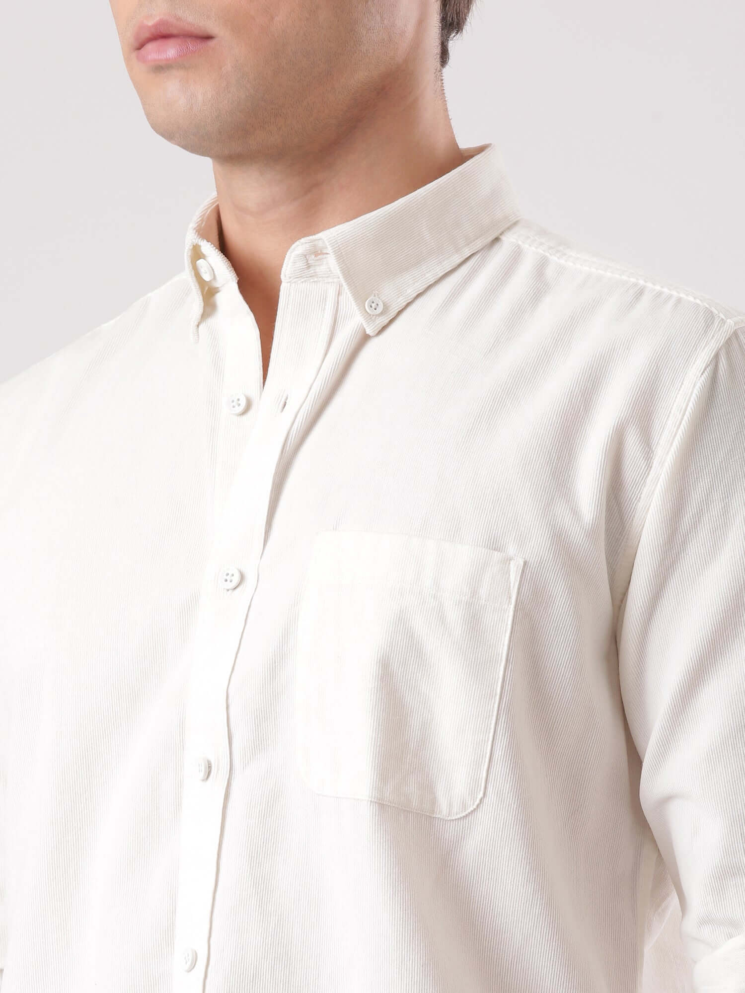 Close-up of a man wearing a White Grizzly corduroy shirt, showcasing its high-quality fabric and design.
